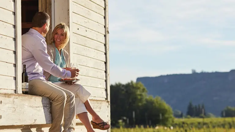 Couple drinking summer wine pairings outside.