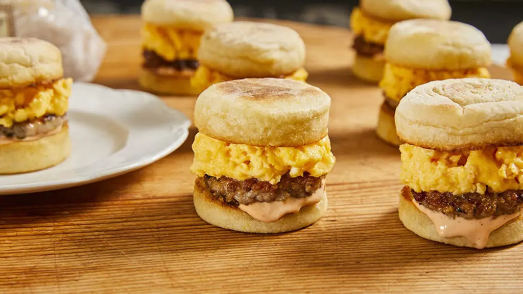 Mini breakfast sandwiches on a table.