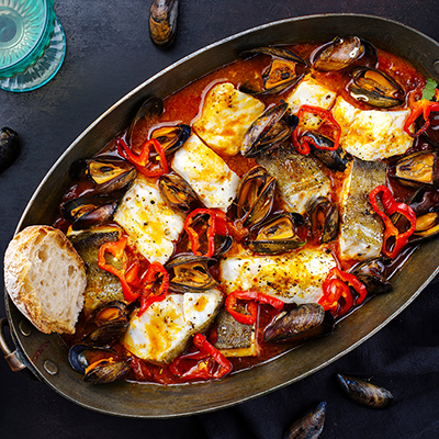 French sea bass bouillabaisse in a dish with crusty bread.