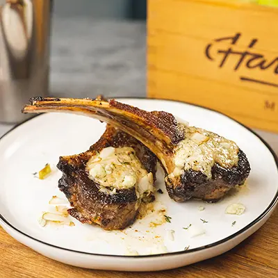 Lamb chops on a plate for New Year's dinner ideas.