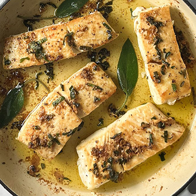 Copper River Seafoods halibut in a pan with butter and sage