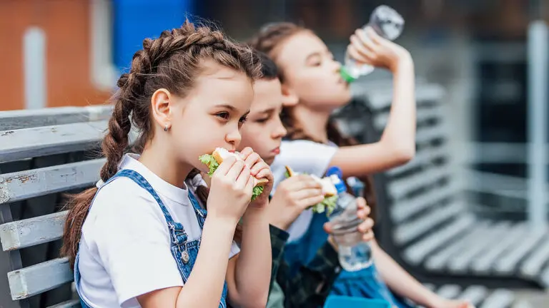 Three child eat, appetizing school lunch. Healthy school lunch: